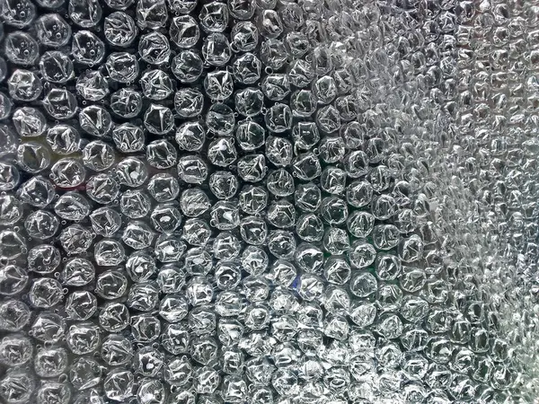 Kabarcıklı plastik yüzey. Siyah nemlendirici plastik ambalaj dokusu. Yüzeyinde hava topları olan plastik.