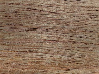 textured background of brown plywood board surface with rough grain scratches and pores