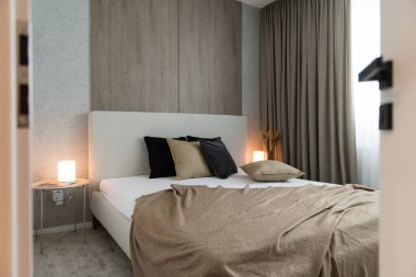 Bed in bedroom of modern apartment