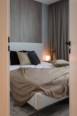 Bed in bedroom of modern apartment