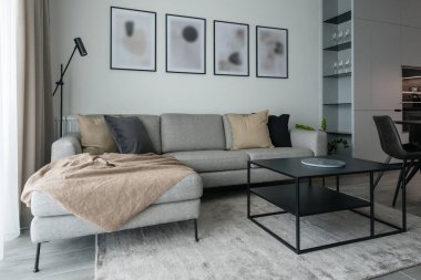 Living-room with sofa and dining table in modern apartment