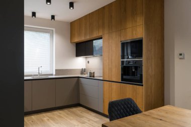 Modern kitchen with built in appliances and dining table