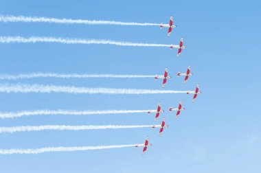 PAYERNE, SWITZERLAND - SEPTEMBER 6: Flight of PC-7 aerobatic team in close formation on AIR14 airshow in Payerne, Switzerland on September 6, 2014
