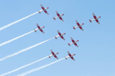 PAYERNE, SWITZERLAND - SEPTEMBER 6: Flight of PC-7 aerobatic team in close formation on AIR14 airshow in Payerne, Switzerland on September 6, 2014