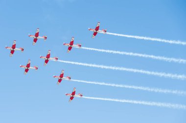 PAYERNE, SWITZERLAND - SEPTEMBER 6: Flight of PC-7 aerobatic team in close formation on AIR14 airshow in Payerne, Switzerland on September 6, 2014