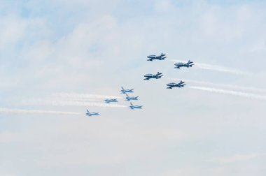 PAYERNE, SWITZERLAND - SEPTEMBER 7: Two groups of airplanes from Frecce Tricolori perform close crossing flight on AIR14 airshow in Payerne, Switzerland on September 7, 2014