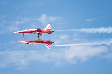 PAYERNE, SWITZERLAND - SEPTEMBER 7: Mirror flight of Patrouille Suisse aerobatic team on AIR14 airshow in Payerne, Switzerland on September 7, 2014