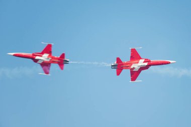 PAYERNE, SWITZERLAND - SEPTEMBER 6: Planes of Patrouille Suisse aerobatic team members are crossing in close distance on AIR14 airshow in Payerne, Switzerland on September 6, 2014
