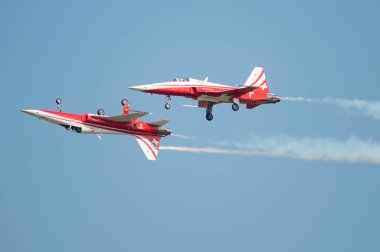 PAYERNE, SWITZERLAND - SEPTEMBER 6: Members of Patrouille Suisse aerobatic team members flying in close distance on AIR14 airshow in Payerne, Switzerland on September 6, 2014