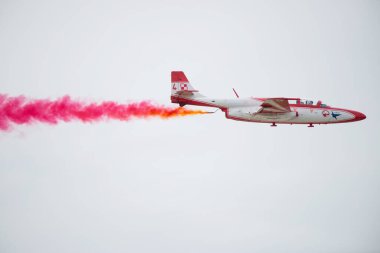 SLIAC, SLOVAKIA - AUGUST 30: TS11 jet of White-Red Sparks releases red smoke on SIAF airshow in Sliac, Slovakia on August 30, 2014