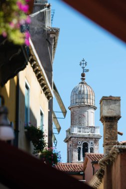 Leaning tower of San Giorgio dei Greci seen from the streets of Venice, Italy