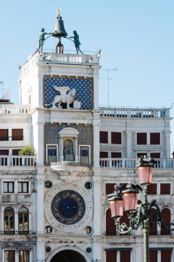 Astronomical Clock Tower with winged lion and two moors striking the bell located on Piazza San Marco, Venice, Italy