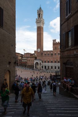 SIENA, ITALY - SEPTEMBER 17, 2014: Tourists on the Piazza del Campo in Siena, Italy. UNESCO a World Heritage Site