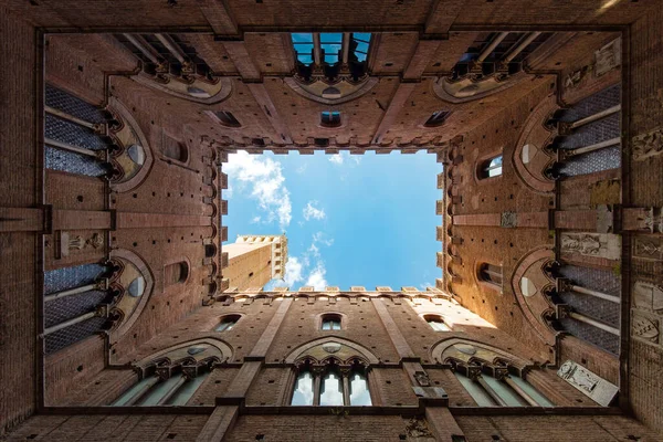 Wide angle view of famous Torre del Mangia at Palazzo Pubblico in Siena, Italy