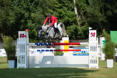 BRATISLAVA, SLOVAKIA - AUGUST 10: Hruska Zdenek (CZE) on horse Calata jumps over hurdle during Mercedes-Benz Grand Prix Bratislava, Slovakia on August 10, 2014
