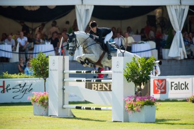 BRATISLAVA, SLOVAKIA - AUGUST 10:  Schneider Miriam (GER) on horse Carena 11 jumps over hurdle during Mercedes-Benz Grand Prix Bratislava, Slovakia on August 10, 2014