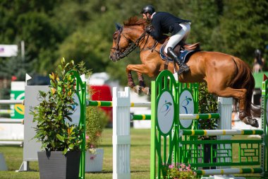 BRATISLAVA, SLOVAKIA - AUGUST 10: Kovacs Kaarlo (FIN) on horse Agropoint Cassius jumps over hurdle during Mercedes-Benz Grand Prix Bratislava, Slovakia on August 10, 2014