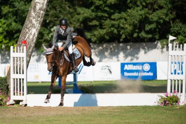 BRATISLAVA, SLOVAKIA - AUGUST 10: Kazmierczak Michal (POL) on horse Stakorado jumps over hurdle during Mercedes-Benz Grand Prix Bratislava, Slovakia on August 10, 2014
