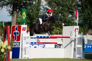 BRATISLAVA, SLOVAKIA - AUGUST 10: Schmid Maximilian (GER) on horse Quabs jumps over hurdle during Mercedes-Benz Grand Prix Bratislava, Slovakia on August 10, 2014