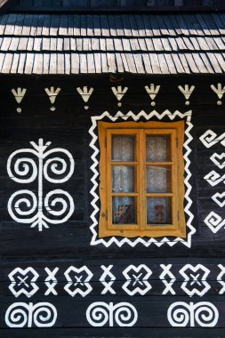 Unique decoration of log houses based on patterns used in traditional embroidery in village of Cicmany, UNESCO World Heritage Site, Slovakia