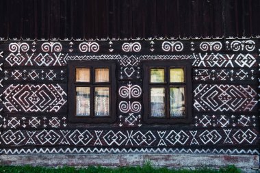 Unique decoration of log houses based on patterns used in traditional embroidery in village of Cicmany, UNESCO World Heritage Site, Slovakia