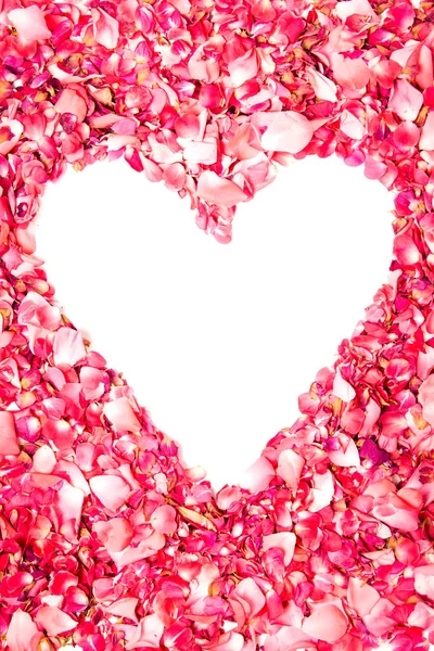 stock image pink rose petals in shape of heart with space for text