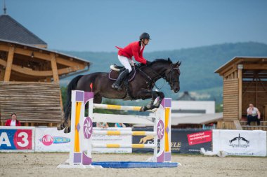 PEZINOK, SLOVAKIA - JUNE 29: Jan Cigan jr. (SVK) on horse Grancor jumps over hurdle on Rozalka Cup 2014 on June 29, 2014 in Pezinok, Slovakia