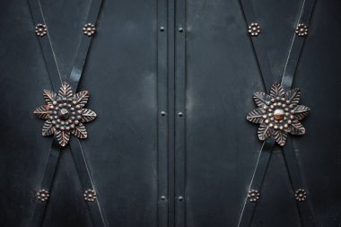 flower ornaments on old black iron door