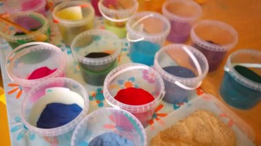 Colored sand in plastic containers, perfect for art and crafts