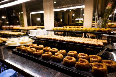 Pasta, pasta ve Türk tatlıları da dahil olmak üzere çeşitli tatlılar her şeyi kapsayan lüks bir otelin masasında güzelce düzenlenmiştir. Gıda, seyahat ve lüks tasarımlarda kullanmak için mükemmel