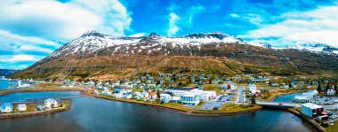 Sakin sular ve karla kaplı dağlarla çevrili İzlanda yarımadasındaki küçük bir kasabanın çarpıcı hava manzarası İzlanda 'nın doğal güzelliğini gözler önüne seriyor..