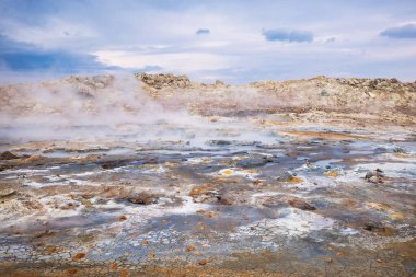 Boiling mudpots in the geothermal area Hverir and cracked ground around. Location: geothermal area Hverir, Myvatn region, North part of Iceland clipart