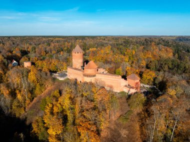 Turaida Kalesi 'nin kırmızı tuğla mimarisi Letonya' nın Sigulda kentinin çevresindeki turuncu, sarı ve yeşilin zengin sonbahar renkleriyle çelişiyor..