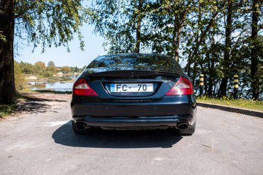 Riga, Latvia - 14.05.2023: Black Mercedes Benz CLS 320 AMG. Static Exterior Image clipart