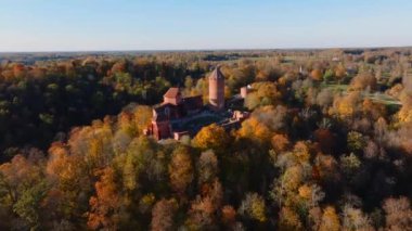 Turaida Kalesi 'nin kırmızı tuğla mimarisi Letonya' nın Sigulda kentinin çevresindeki turuncu, sarı ve yeşilin zengin sonbahar renkleriyle çelişiyor..