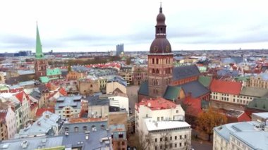 Riga, Letonya 'nın havadan görünüşü, Riga Katedrali' nin kubbesini ve saatini vurguluyor, arka planda Aziz Peter Kilisesi 'nin kulesi ve çeşitli mimarinin ortasında yer alıyor..