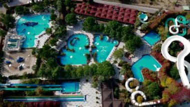 Canlı su parkında havuzlar, sarmal slaytlar, bir korsan gemisi oyun alanı ve yemyeşil ağaçlar ve renkli yapraklarla çevrili tembel bir nehir bulunuyor..