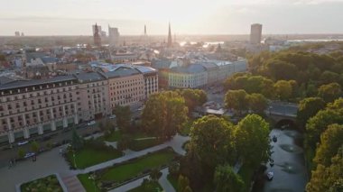 Aerial view of Riga, Latvia, featuring the Monument of Freedom, historic architecture, St. Peter's Church, Riga Cathedral, and the Daugava River.