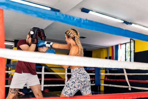 stock image Young adult man and woman training box on the ring. Concept of box and training.