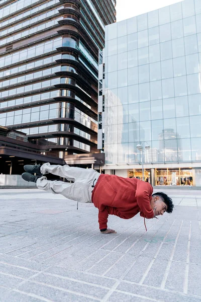 大規模な近代的な建物に対して街でブレイクダンスを練習才能の少年 — ストック写真
