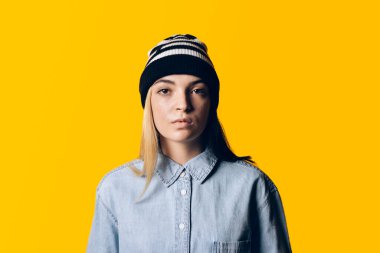 Stock photo of young pretty girl looking at camera in studio.