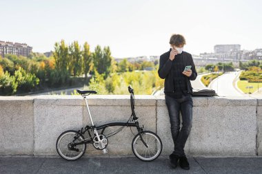 Stock photo of young man using his cellphone in the street.