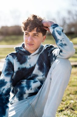 Stock photo of cool boy wearing urban clothes smiling and looking to the side.