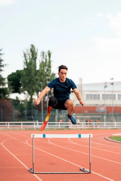 stock image Stock photo of young athlete training with leg prosthesis in running track.