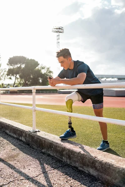 Disabled Man Athlete Using His Phone While Doing Break Royalty Free Stock Photos