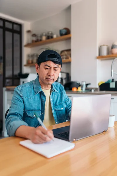 Vertical Photo Asian Man Taking Notes While Working Laptop Kitchen Stock Photo