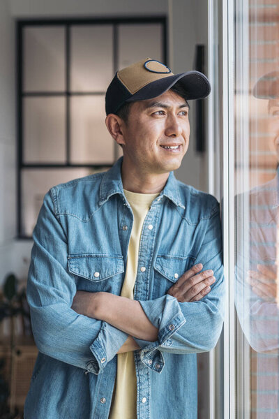 Vertical Portrait Relaxed Asian Man Looking Away Window Standing Home Stock Image