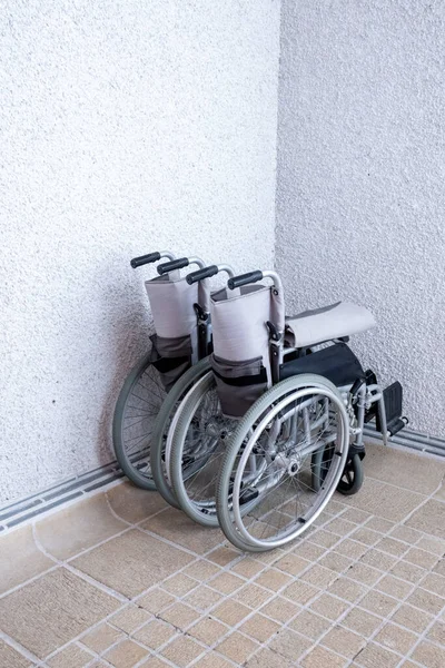 two wheel chairs in a corner