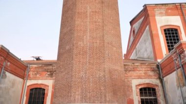 Tall chimney in worker village of Crespi d'Adda, unesco heritage, Lombardy, Italy