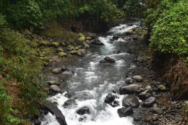 gurgling clear waterfall flow in the cool mountains of Indonesia. This waterfall flow is a source of water and beautiful tourism.